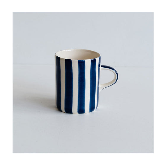 A colourful handcrafted mug from Musango in their Blue candy stripe glaze. 