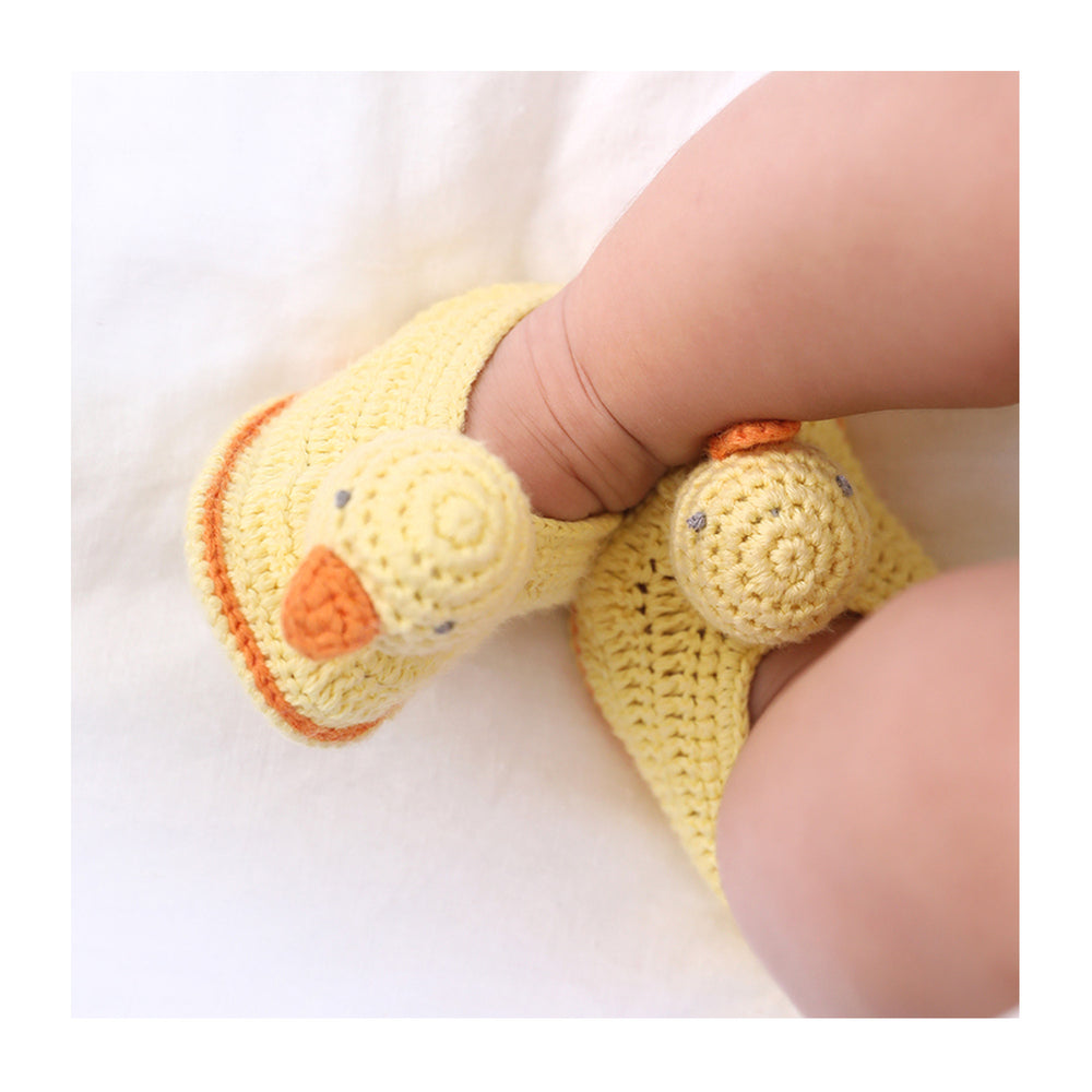 
                  
                    Handcrafted crocheted baby booties in the shape of chicks. Charly Chick booties are bright yellow with orange trims and orange beaks.
                  
                