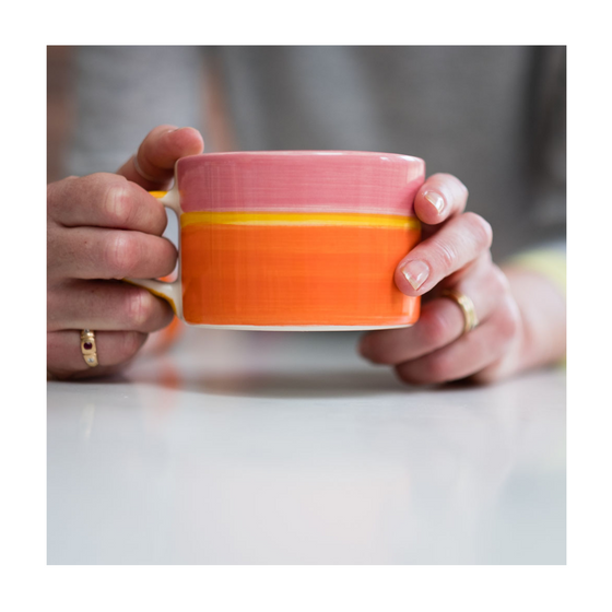 A colourful handcrafted mug from Musango in their Sunrise tri-colour glaze.