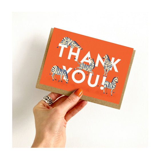 A fun and colourful thank you card from Emily Nash featuring some playful zebras. The perfect greeting!