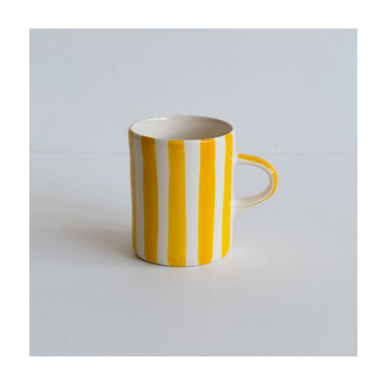 A colourful handcrafted mug from Musango in their Turmeric candy stripe glaze.