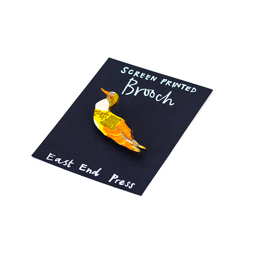 A screen printed brooch, handcrafted by East End Press.