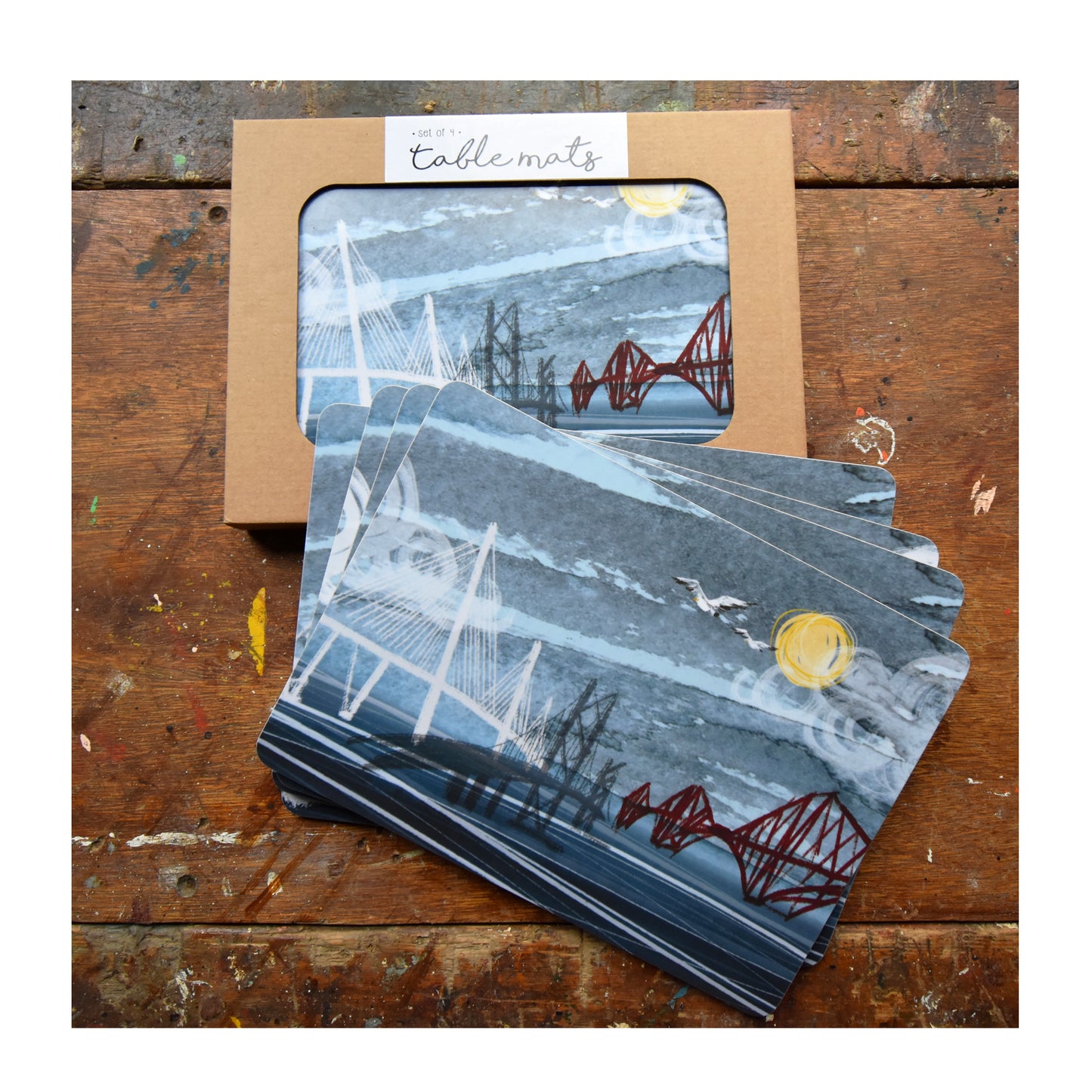 Set of 4 cork backed, melamine rectangular tablemats featuring 4 different illustrations of the 3 Bridges by Tori Gray.