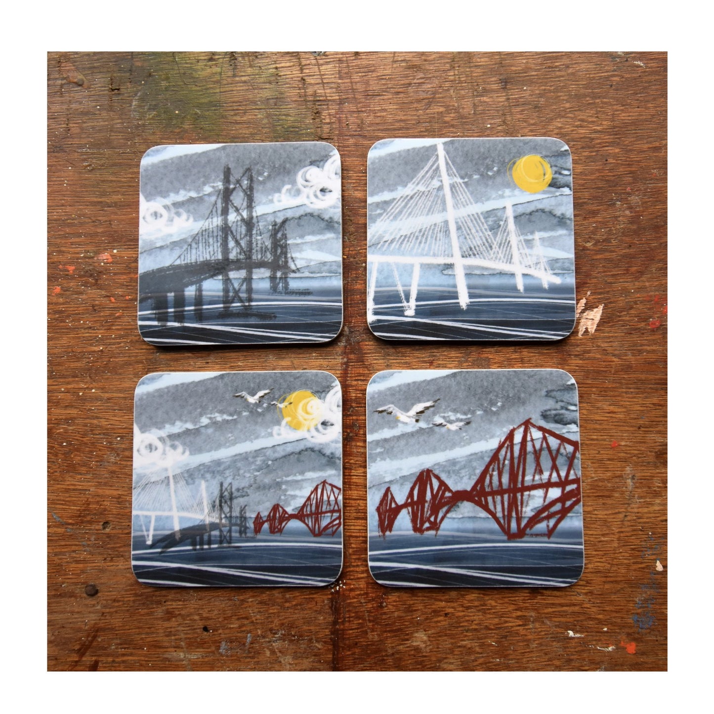 Set of 4 cork backed, melamine coasters featuring 4 different illustrations of the 3 Forth Bridges by Tori Gray. 