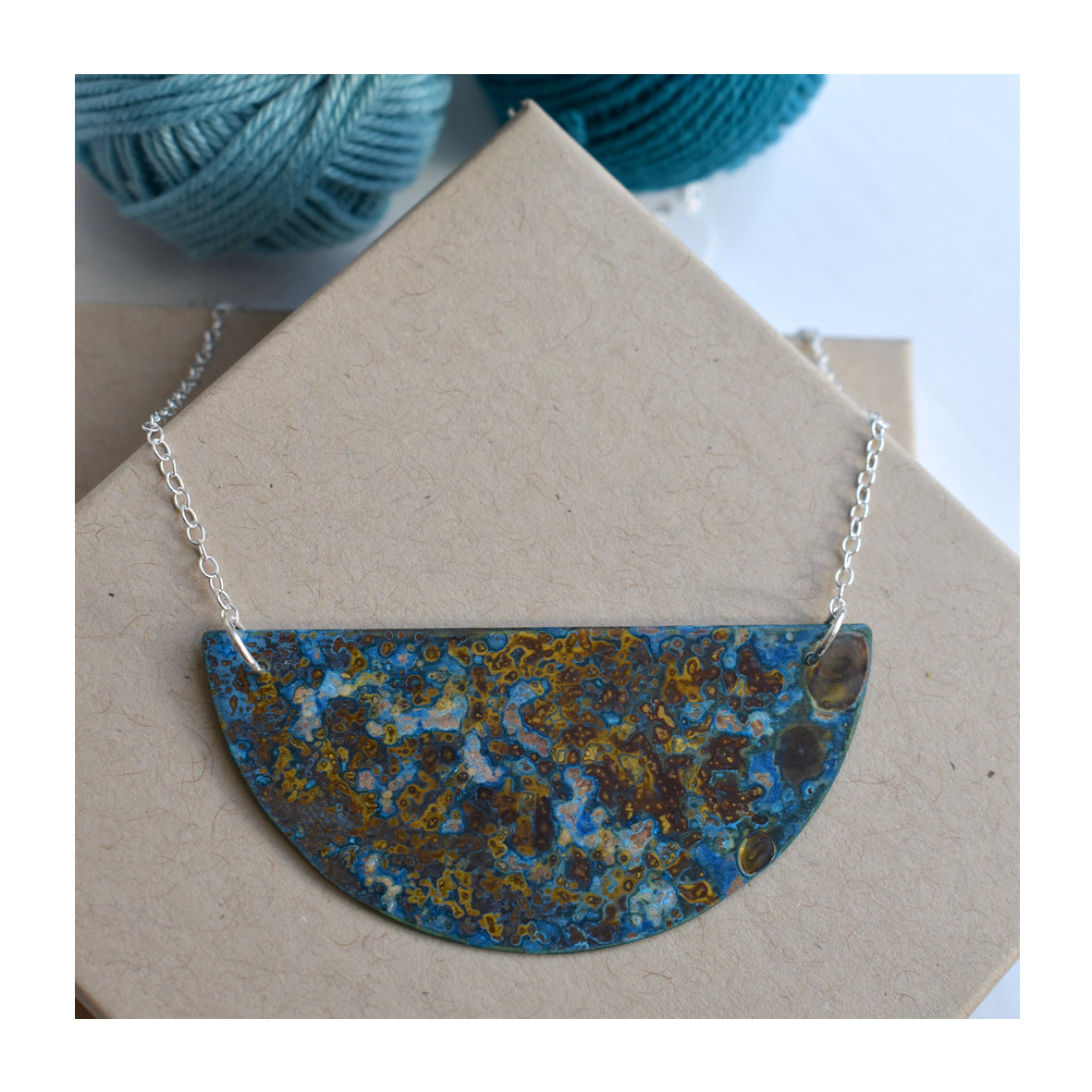 Small patinated brass crescent necklace by Stephanie Hopkins